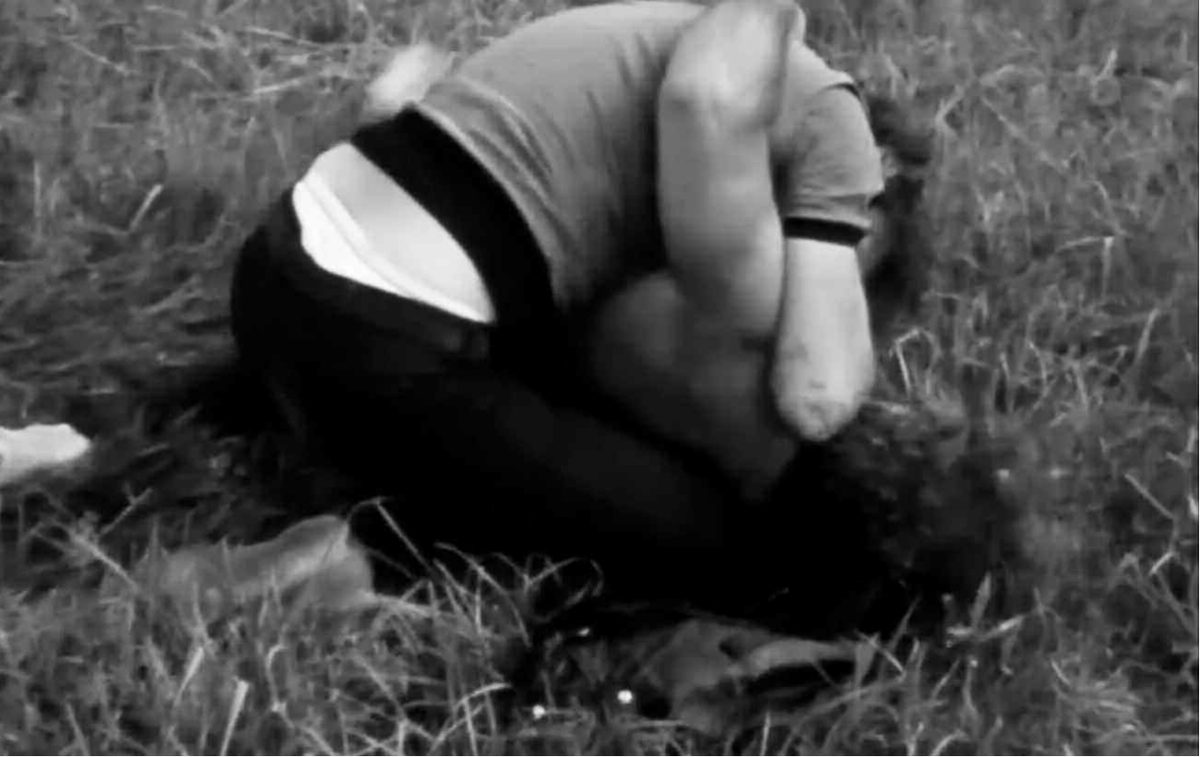 Figure 2.6: Torn pins Mailer on the ground after unexpectedly attacking him with a hammer, while a cameraman and sound technician continue to record.